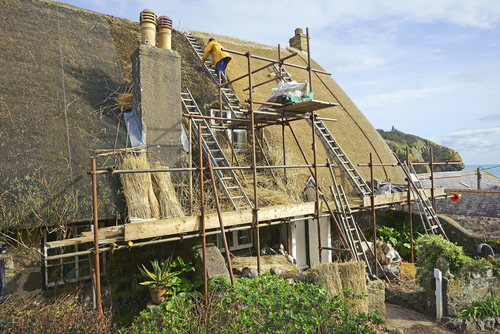 A thatcher at work on a new roof